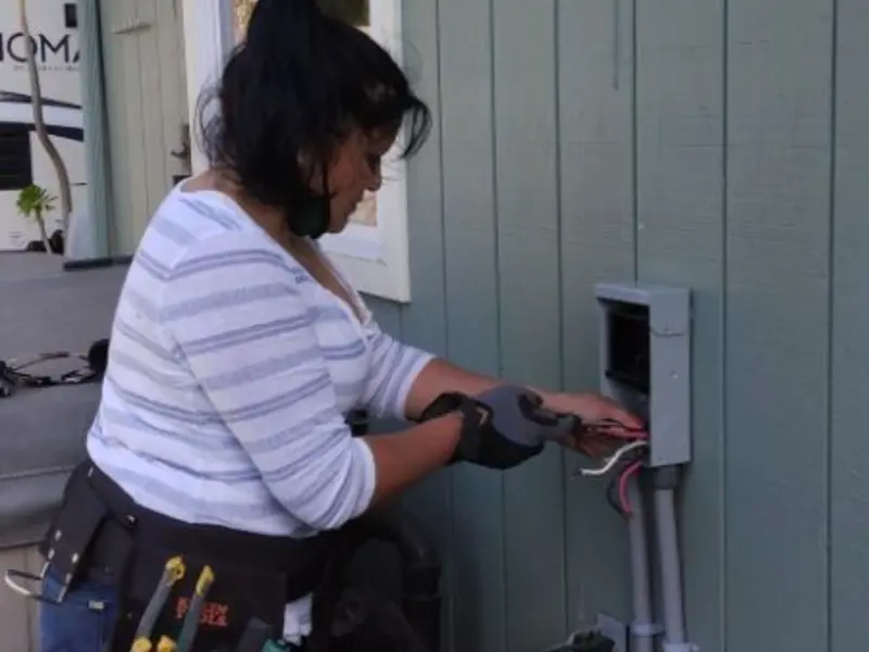 Licensed electrician wiring an exterior subpanel in Madison