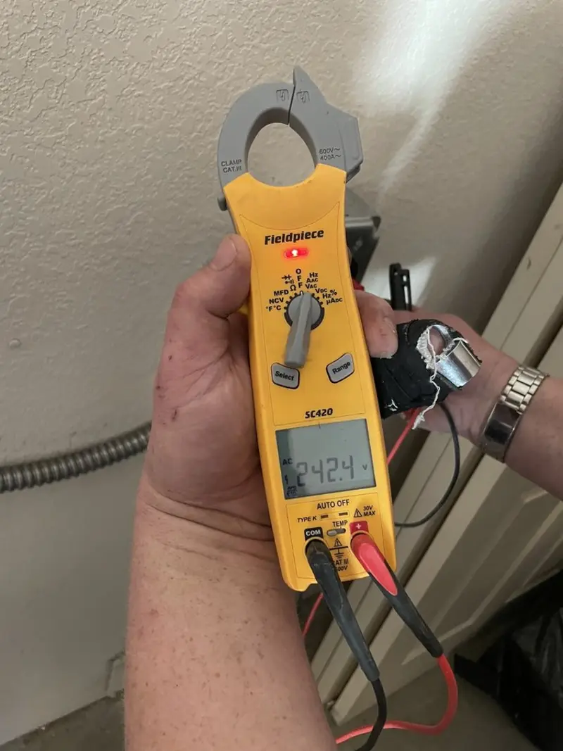 Voltage testing with clamp meter during Whole House Surge Protector in Madison